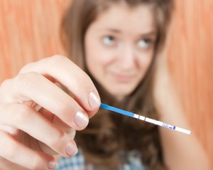 Woman looking at a pregnancy test
